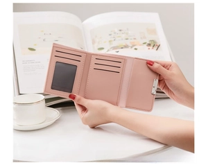 Internal view of pink trifold wallet showing ID window, card slots and inner compartments