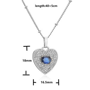 Macro view of silver heart necklace showing 18x16.5mm dimensions and blue gem detail