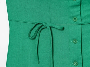 Detailed macro view of the linen blend green maxi dress with waist tie and button closure
