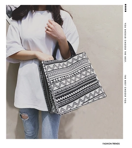 Detail of bohemian tote bag with black and white geometric pattern and webbing handles