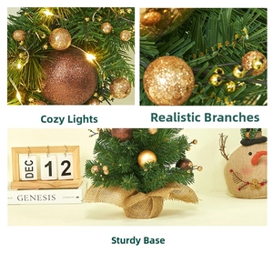 Tabletop Christmas tree detail with golden ornaments and LED lights on burlap base