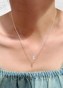 Close-up of 925 sterling silver necklace with marquise-cut zircon pendant on neck