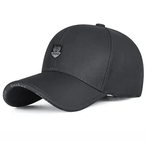 Detailed view of black twill baseball cap with shield embroidery and brim branding