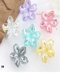 Macro detail of six aurora floral hair claws showing iridescent finish and secure springs