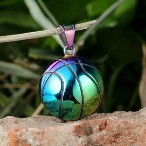Macro shot of a rainbow-colored basketball pendant with polished metallic finish