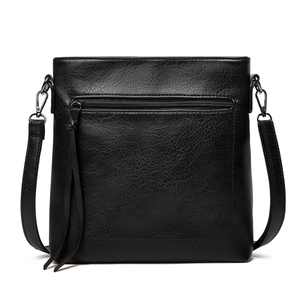 Close-up of black PU leather tote bag with tassel zipper and metallic buckle detail