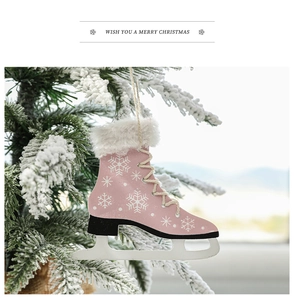 Detail of pink wooden ice skate Christmas ornament with white fur hanging on a snowy branch
