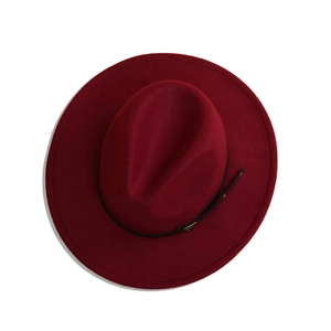 Close-up of wine red wool fedora hat featuring a black leather belt with metal buckle detail