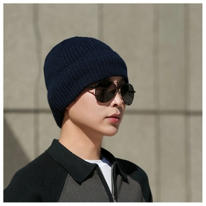 Outdoor side view of navy blue ribbed knit beanie showing warm thick texture and fit