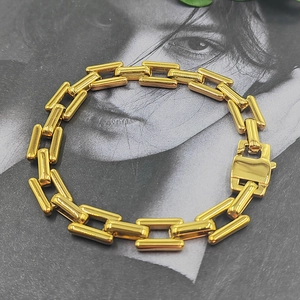 Close-up of gold stainless steel thick rectangular chain bracelet with fold-over clasp