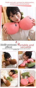 Detail showing plush cherry-shaped neck pillow used as travel U-shaped support cushion