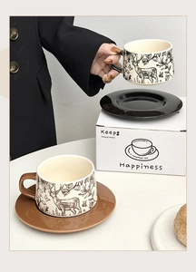 Detailed view of ceramic coffee cup and saucer sets featuring elegant deer patterns