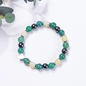 Natural agate stone beaded bracelet with silver heart pendant on white background