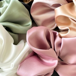 Close-up of assorted colors oversized satin scrunchies with soft silk texture and luster