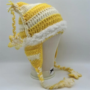 Detail of yellow striped knit cat ear hat with star pendants and faux fur trim