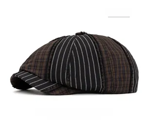 Detail of vintage patchwork newsboy cap featuring black stripes and brown plaid texture