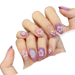 Lilac purple handmade press-on nails with 3D white floral designs and gold beads
