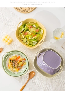 Flat lay of colorful ceramic air fryer bowls with double handles on a lace runner