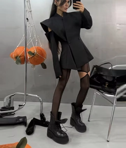 Detailed full-body shot of a black slim-fit off-shoulder blazer with avant-garde tailoring
