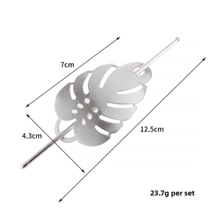 Macro detail of silver monstera leaf hair clip with dimensions 7x4.3cm and 12.5cm stick