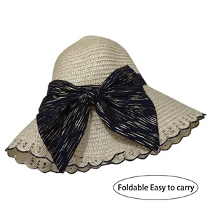 Foldable lace straw sun hat for women with oversized black bow and wavy edge detail