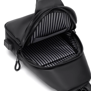 Men waterproof sling chest bag with USB port and striped lining for outdoor travel.