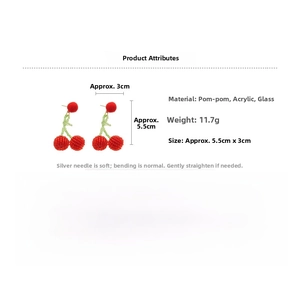 Detail view of red cherry earrings made of fluffy pom poms and green acrylic beads
