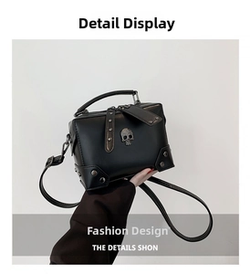 Detailed view of punk style black box bag with metal skull and rivet decorations