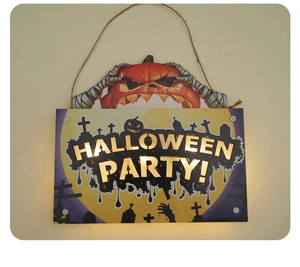 Close-up of LED Halloween sign with pumpkin and graveyard design hanging on a wall