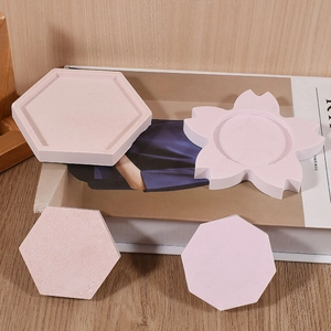 Close-up of pink hexagonal and flower-shaped plaster coasters for jewelry and resin crafts