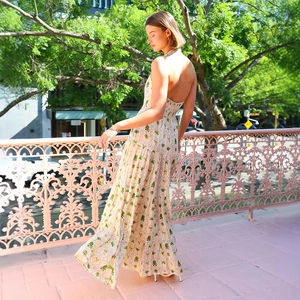 Halter backless floral maxi dress with green coconut tree prints on beige fabric