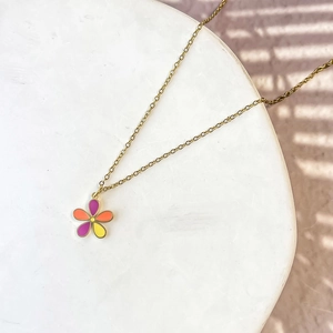 Macro shot of a colorful flower pendant necklace with vibrant oil-dripped enamel petals