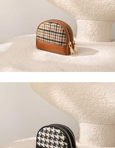 Detail view of double-zippered canvas coin purses in plaid and houndstooth patterns