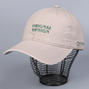 Beige cotton baseball cap with green letter embroidery on a metal display stand