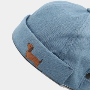 Bonnet Miki en denim bleu clair avec broderie détaillée d'un teckel brun sur le bord plié
