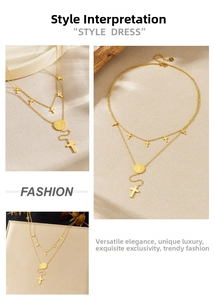 Close-up of golden double-layer chain necklace with cross pendants and coin medal detail