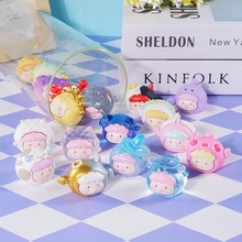 Close-up of colorful resin bear figurines on blue checkered fabric with props