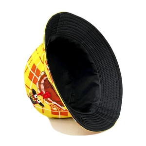 Detailed view of yellow plaid bucket hat with turkey print and black lining texture