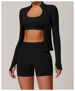 Detail of black seamless yoga jacket with thumbholes and high-waist sports shorts