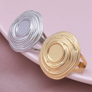 Macro view of gold and silver stainless steel rings with spiral texture on round base