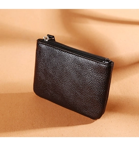 Close-up of black lychee grain PU leather coin purse with secure zipper closure