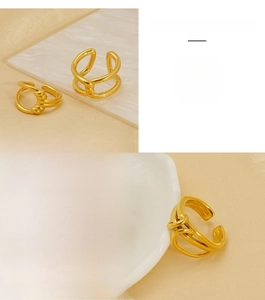 Detail showing 18K gold-plated stainless steel rings with irregular geometric spiral design