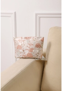 Floral embroidery detail on a portable makeup bag featuring H & R BAG woven label