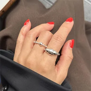 Detailed view of S925 sterling silver beaded ring and croissant ring set on hand