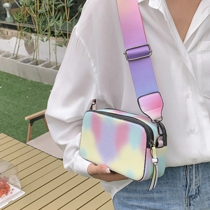 Rainbow gradient crossbody camera bag with wide strap and silver metal hardware