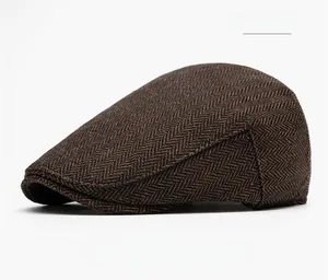 Detail shot of coffee herringbone tweed newsboy cap showing vintage texture and weave