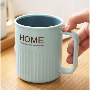 Minimalist two-tone plastic mouthwash cup with anti-slip stripes and handle in light blue