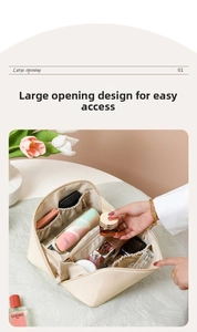 Detailed interior of large capacity cream cosmetic bag with dividers and elastic pockets
