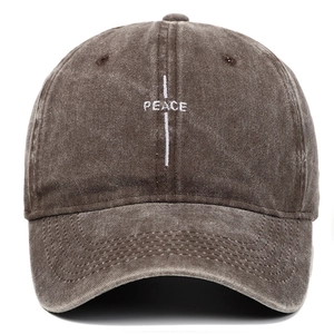 Close-up of vintage washed cotton baseball cap with white PEACE embroidery detail