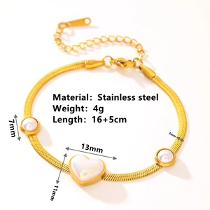 Bracelet en acier inoxydable doré avec perle blanche et pendentif cœur sur fond blanc